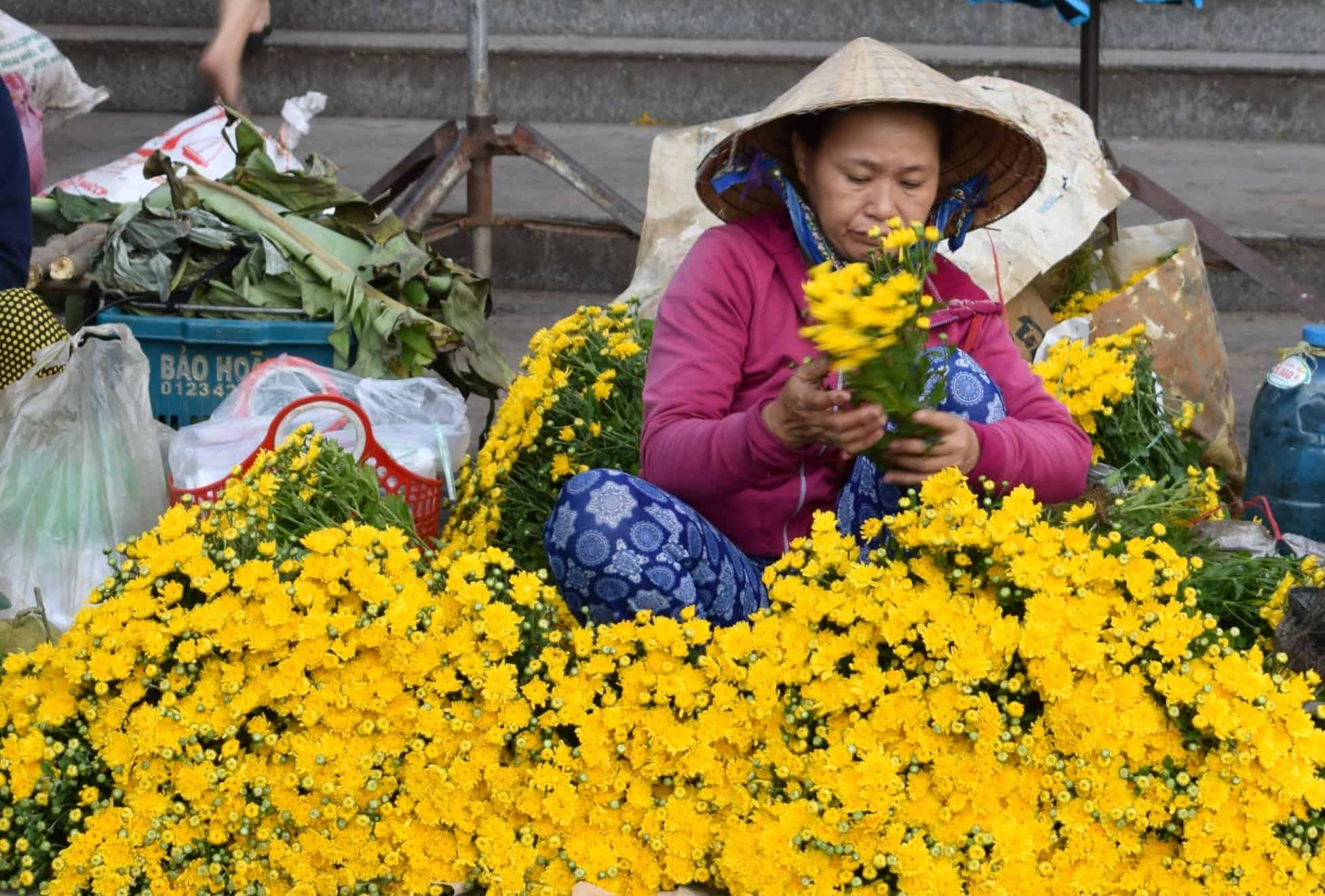 Selling flowers at Hoi An Market Vietnam